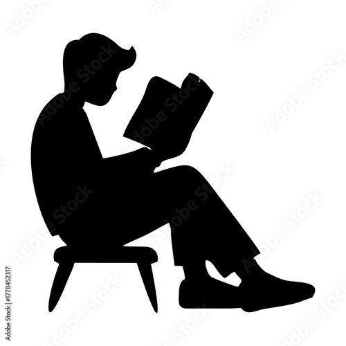 silhouette of a person reading a book