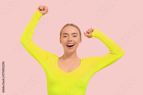 Happy young woman celebrati...