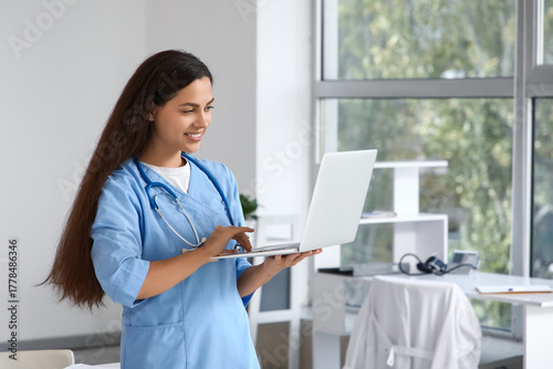 Young female doctor with la...