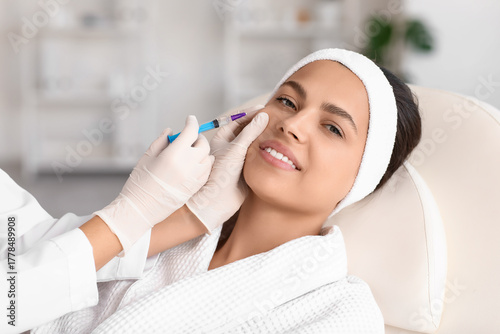 Young woman receiving cheek...