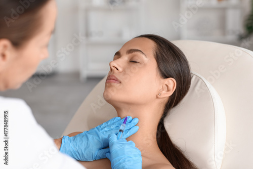 Young woman receiving neck ...