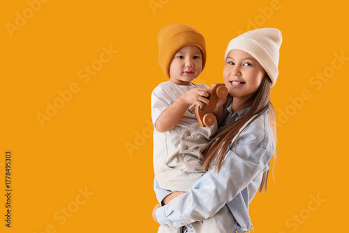 Teenage girl holding her li...