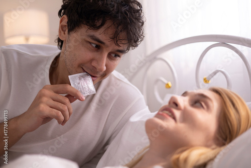 A man who wants to have sex with his wife gets sexually aroused and uses a condom.