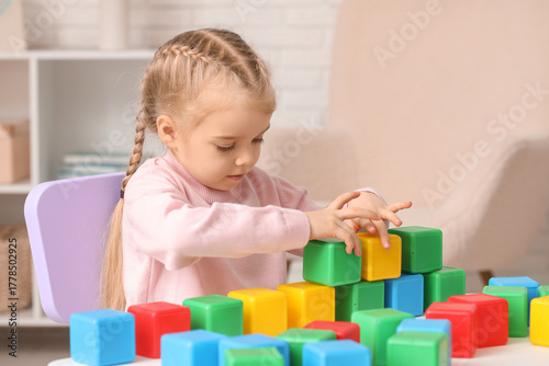 Cute little girl playing wi...
