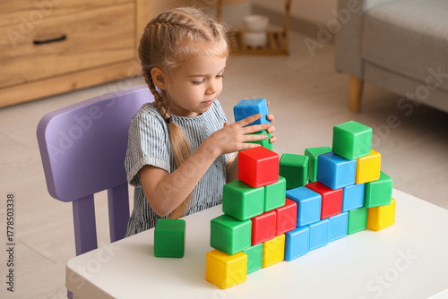 Cute little girl playing wi...