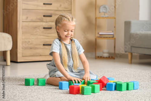 Cute little girl playing wi...