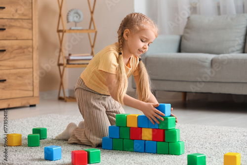 Cute little girl playing wi...