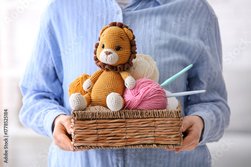 Young woman holding basket ...