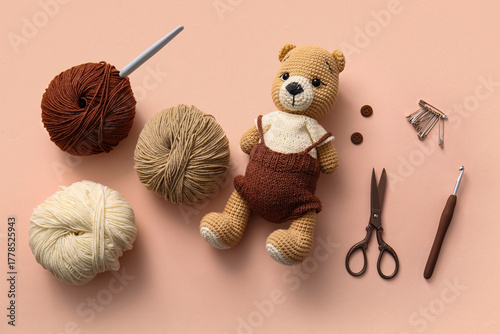Knitted bear toy with yarn,...