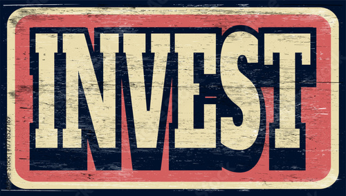 Aged and worn retro invest sign on wood