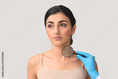 Dermatologist with magnifyi...