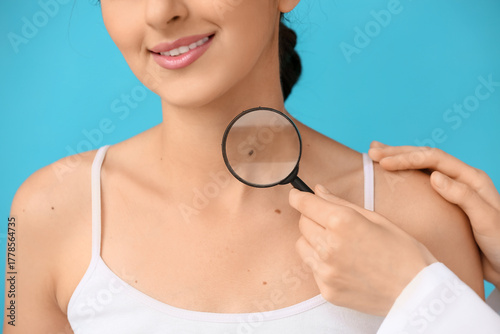 Dermatologist with magnifyi...