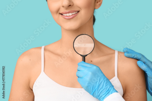 Dermatologist with magnifyi...