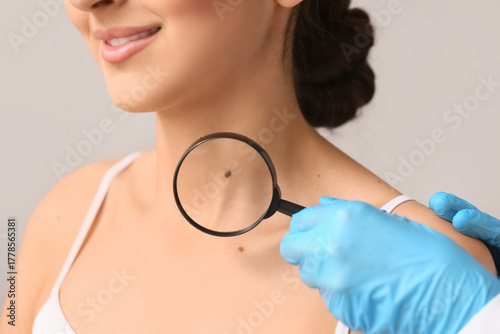 Dermatologist with magnifyi...