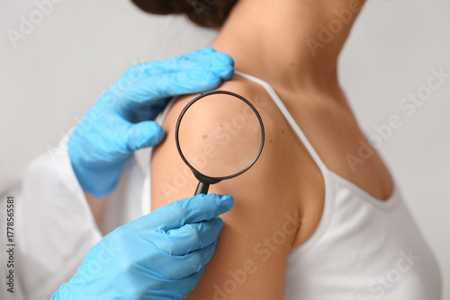 Dermatologist with magnifyi...