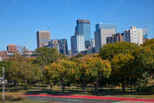 Skyline of city with large buildings and towers with a park in the foreground