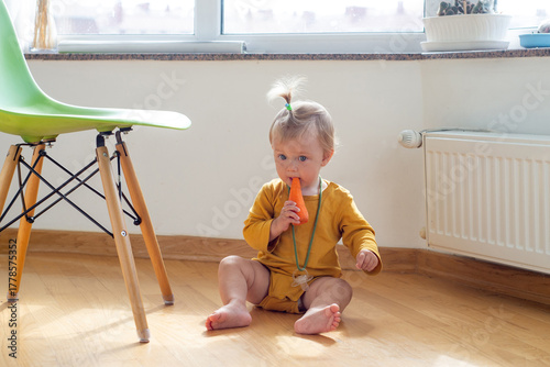Toddler nibbling on a carrot