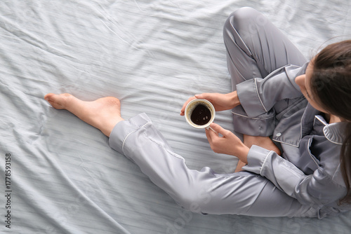Young woman in pajamas with...