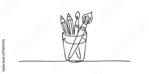 Cup of drawing tools with pencils and brushes
