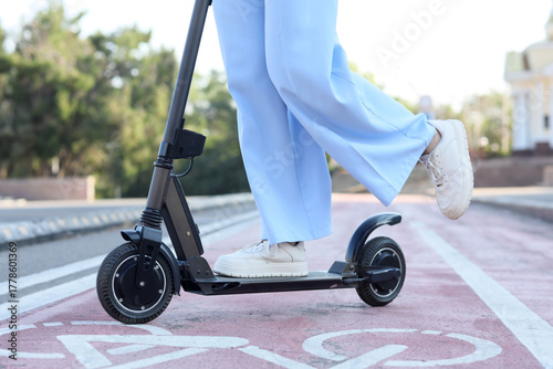 Young woman riding electric...