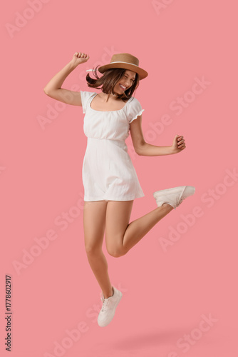 Joyful young woman in white...