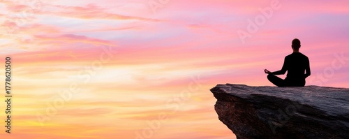 Wellness fitness holistic concept. Serene figure meditating on a rock at sunset, surrounded by vibrant sky colors.
