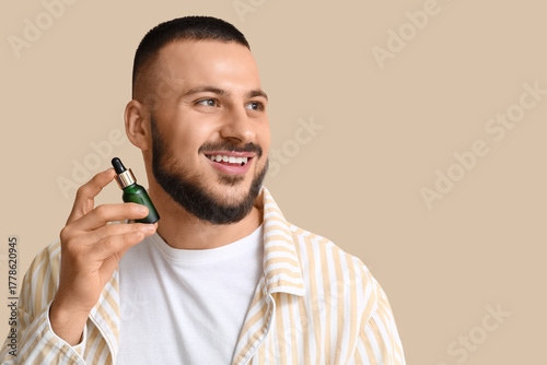 Happy young man with bottle...