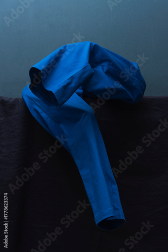 Man Dressing in Blue Against Tonal Backdrop