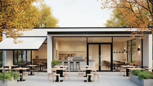 Modern cafe with outdoor seating and autumn trees