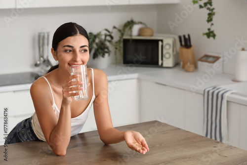 Young woman with vitamin E ...