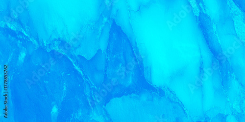 Elegant abstract marble pattern in blue colors featuring delicate white veins and shimmering metallic accents.