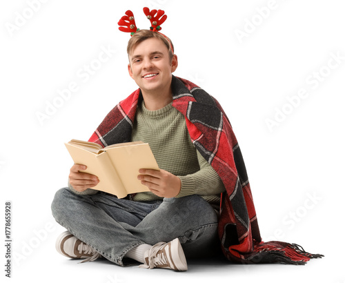 Young man reading book on w...