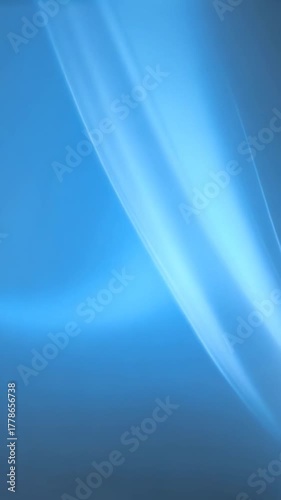 Gentle curved blue light streaks move across gradient background creating elegant flowing motion and futuristic abstract visual texture