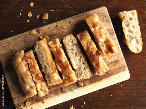 top view garlic focaccia bread sticks on wooden board