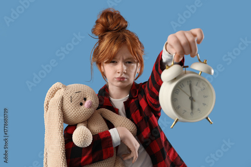 Sleepy girl in pajamas with...