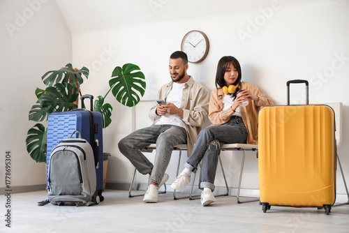 Young couple with luggage w...