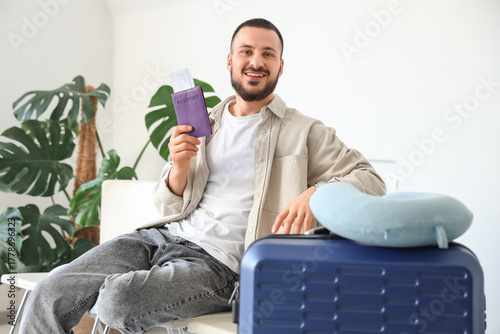Young man with passport wai...