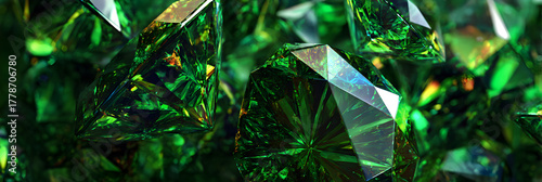 A collection of sparkling green emeralds, each precisely cut and faceted, creating a dazzling display of light and color in a luxurious arrangement