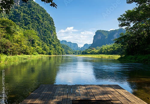 Photo of a peaceful river with green mountains and wooden platform in the foreground