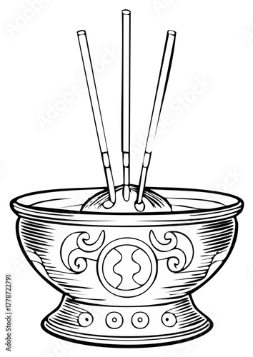 Incense sticks in an ornate decorative bowl emitting a serene aroma