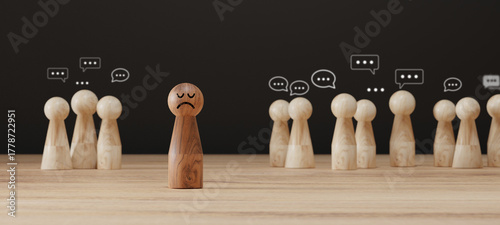 Sad wooden figure excluded from group. Concept of bullying, discrimination, isolation, loneliness, and mental health in society, workplace or school.
