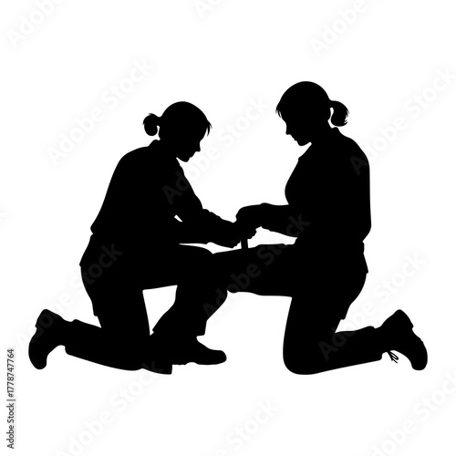 People assisting with medical care assistance kneeling