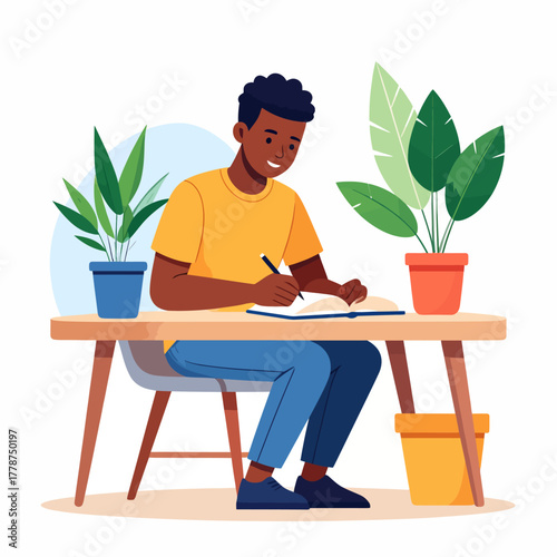 Smiling young Black man with curly hair, wearing a yellow shirt, diligently writing in a notebook at a wooden desk.