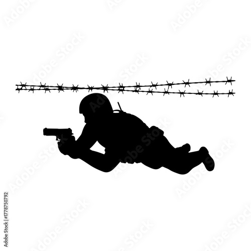 Soldier crawling with gun under barbed wire pistol