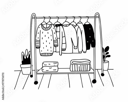 Clothes rack with sweaters and plants