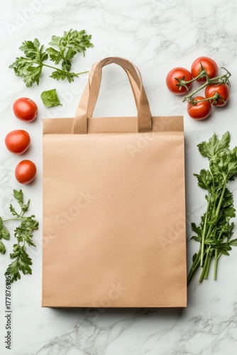 Brown paper bag with fresh tomatoes and green herbs on a white marble surface, simple presentation of garden produce.