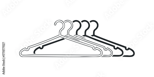 Five black clothes hangers lined up on a white surface