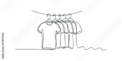 Continuous line drawing of t-shirts hanging on a clothesline