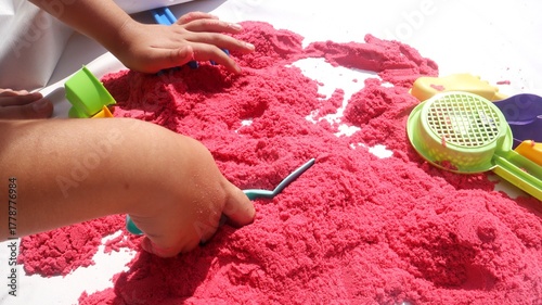 Bright pink Kinetic Sand Play with Colorful Play Toys for Sensory Fun.