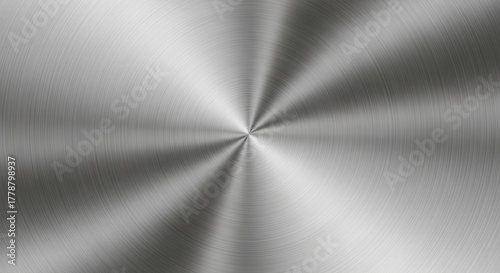 Close-up view of a brushed metal texture with a radial pattern, creating a sleek and modern background.